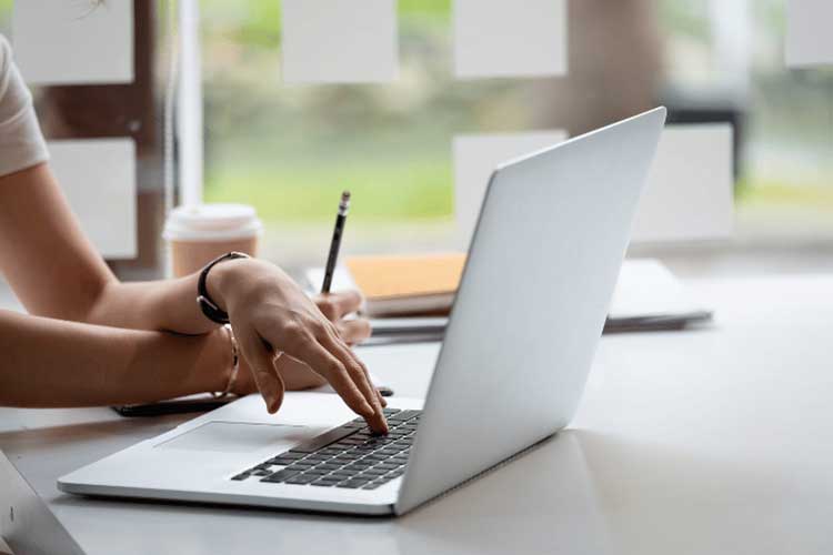 Hands on a laptop keyboard